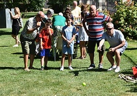 Veteranos y pequeños jugando a la petanca