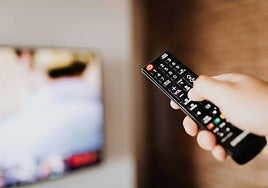 Una persona seleccionando que serie quiere ver en la tele.