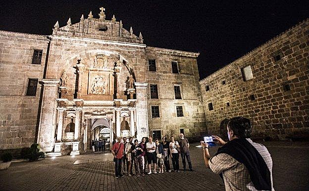 Un grupo se fotografía frente a la fachada monumental que da acceso al monasterio.