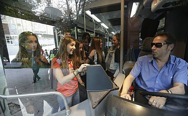 Un jupo de jóvenes accede al autobús urbano. 