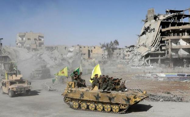 Los combatientes de las Fuerzas de Siria Democrática recorren Raqqa a bordo de blindados para celebrar la victoria. :: Erik De Castro / reuters