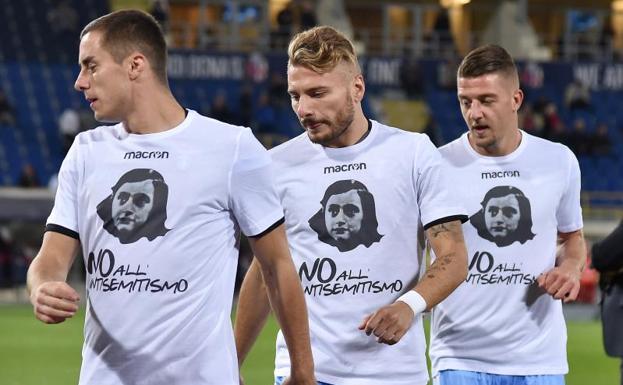 Los jugadores de la Lazio calientan con camisetas con la foto de Ana Frank y el lema "No al antisemitismo". 