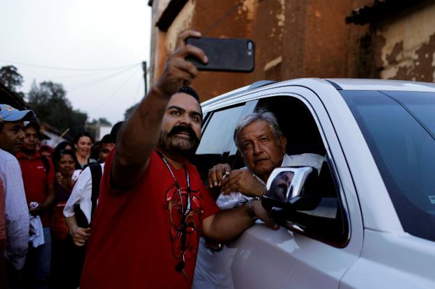 Andrés Manuel López Obrador, candidato del Movimiento de Regeneración Nacional (Morena) posa para un selfie con un seguidor. 