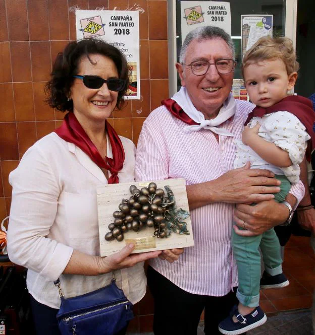 Tomás Santos, su mujer y su nieto recogiendo el premio. :: J. herreros