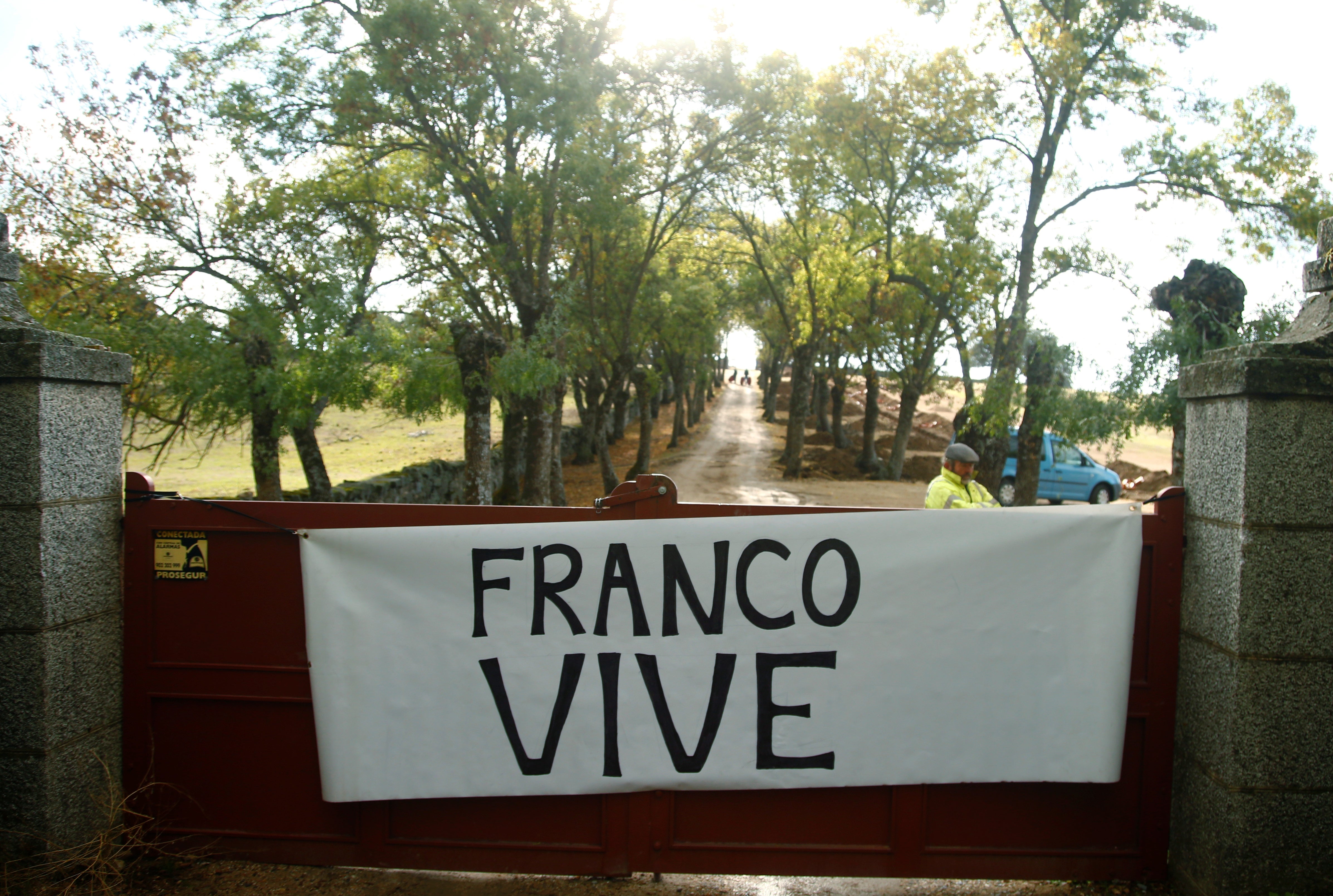 Simpatizantes de Franco cuelgan una pancarta en la que se lee 'Franco vive', a la entrada del Valle de los Caídos.