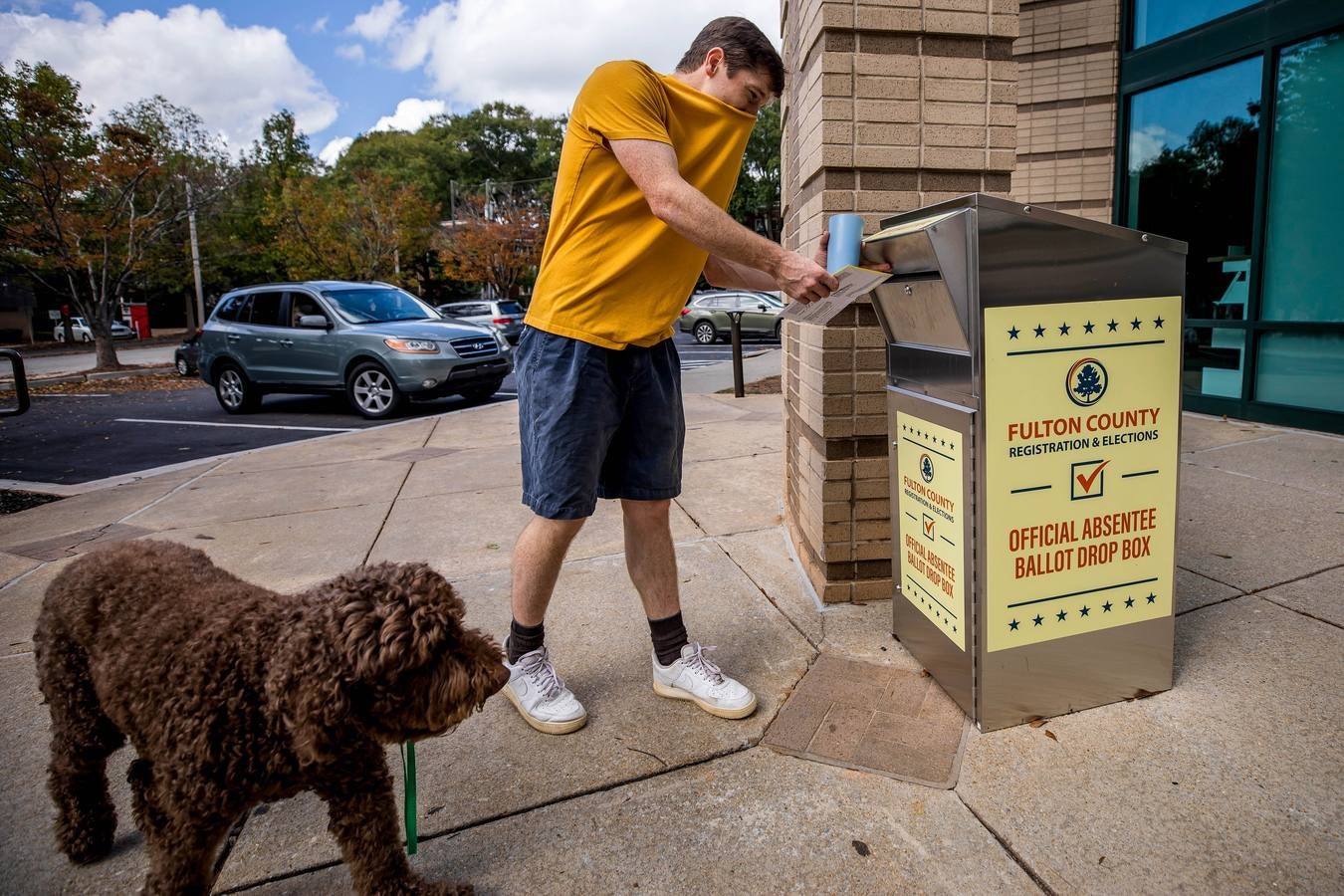 Un hombre coloca su voto en un buzón del condado de Fulton fuera de la sucursal Ponce De Leon del sistema de bibliotecas públicas de Atlanta-Fulton, en Atlanta, Georgia.