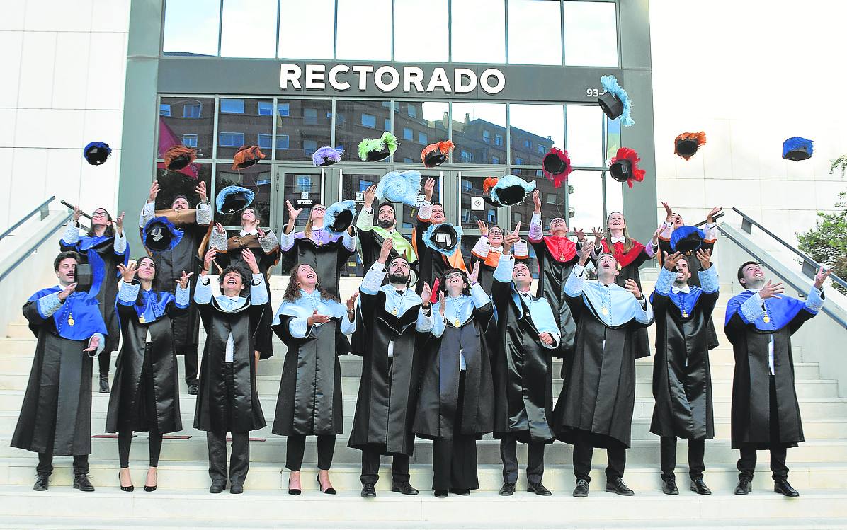 Los nuevos doctores lanzan al aire sus birretes a las puertas del rectorado.