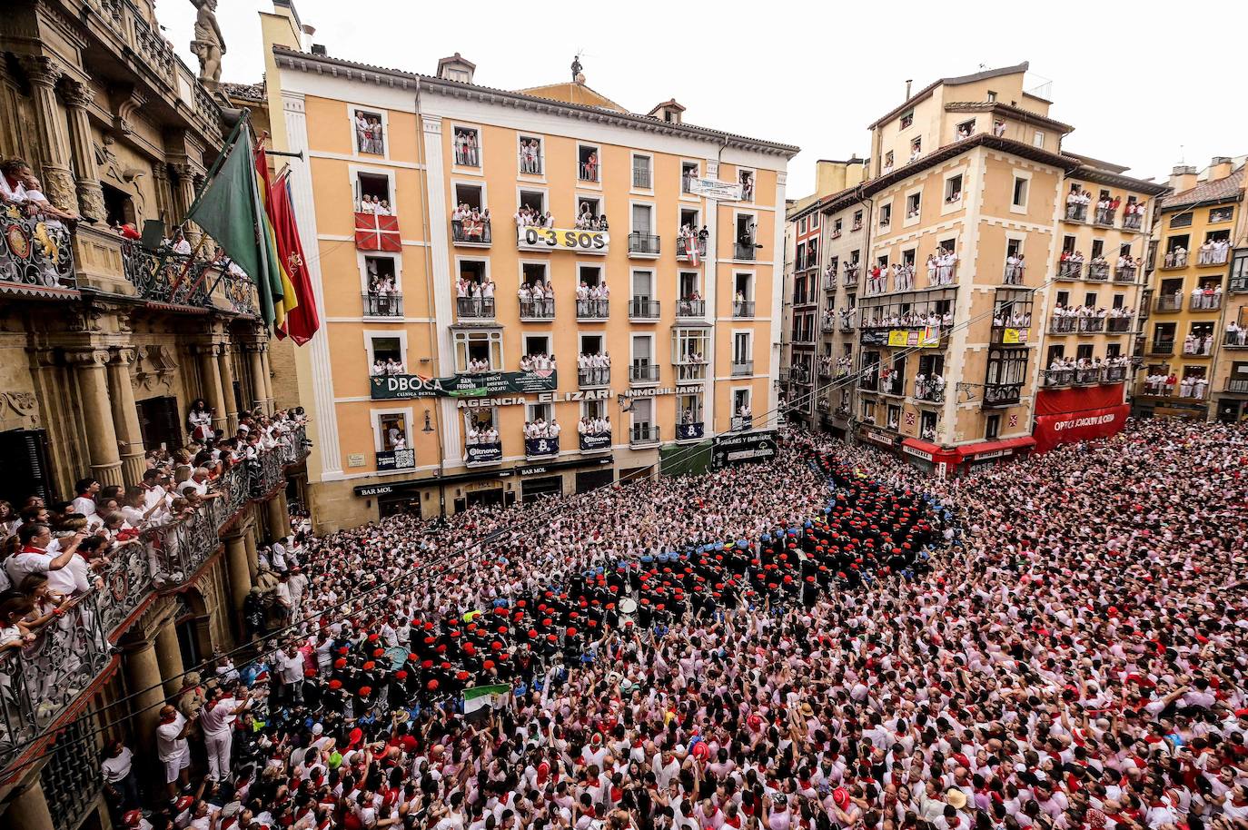 Una espectacular viosta general de la Plaza Consistorial de Pamplona atestada de gente minutops antes del chupinazo. 