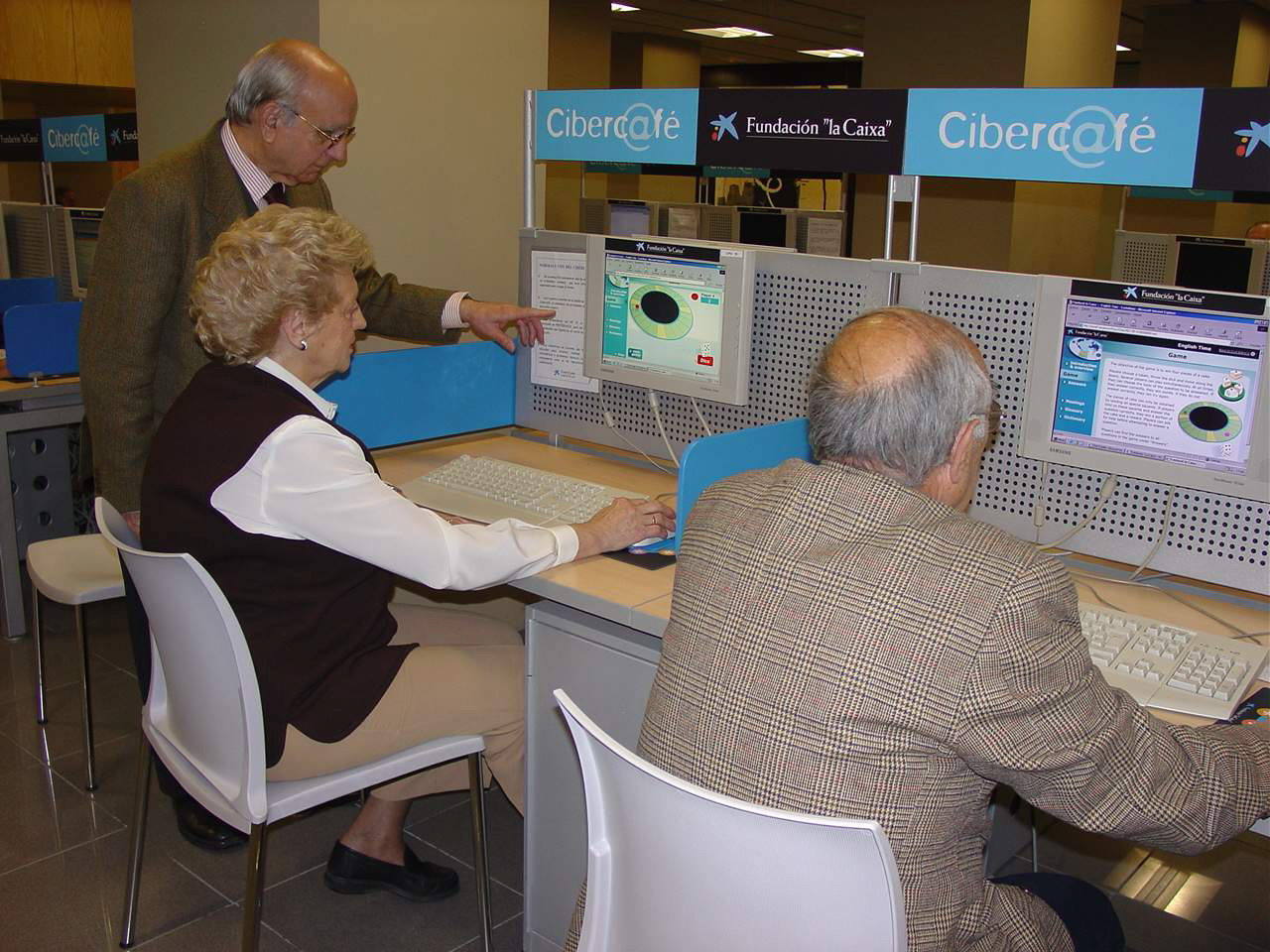 Dos personas mayores se forman en informática. 