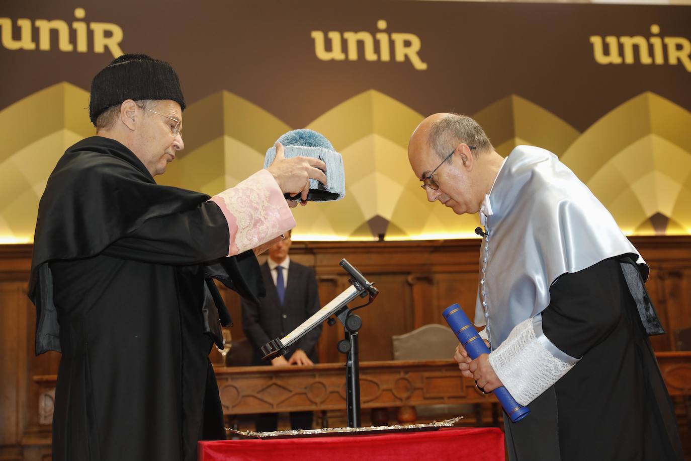 José María Vázquez coloca el birrete a Juan Carlos Vergara Silva, director de la Academia Colombiana de la Lengua. 