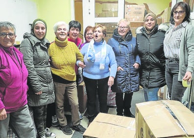 Imagen secundaria 1 - Arriba, parte de los miembros del colectivo Alberite Solidario. Debajo, a la izquierda: integrantes de la entidad social y de la asociación Arabella. A la derecha: personas de diferentes entidades cargan cajas en el camión. 