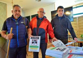Javier Albo, José Ramón Cañas y Rodrigo Monasterio recogen unos carteles del bar La Mina antes de emprender una nueva búsqueda.