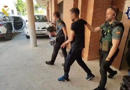 Los agentes, con uno de los detenidos.