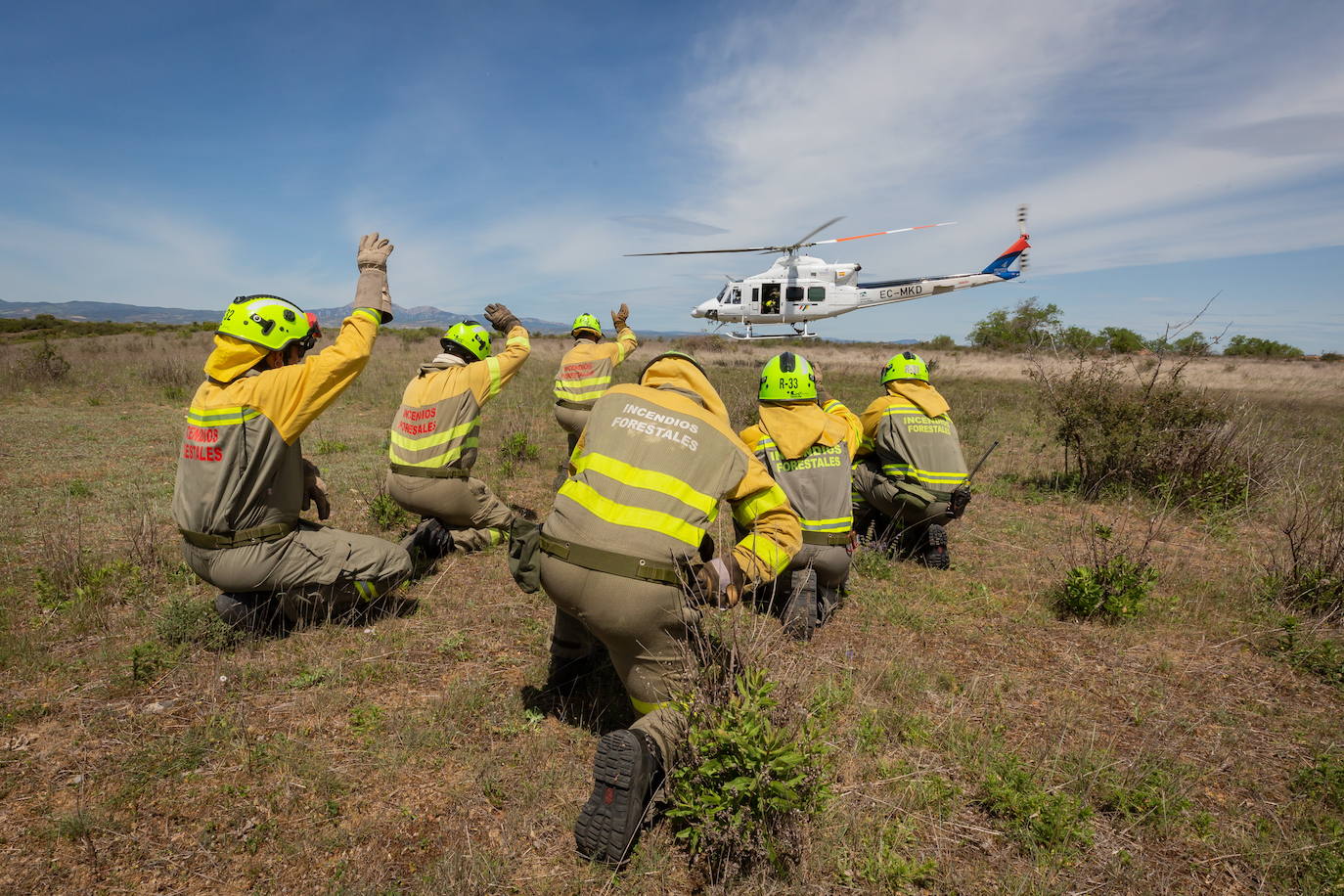 un retén de incendios junto al helicóptero de Medio Natural, en una imagen de archivo.