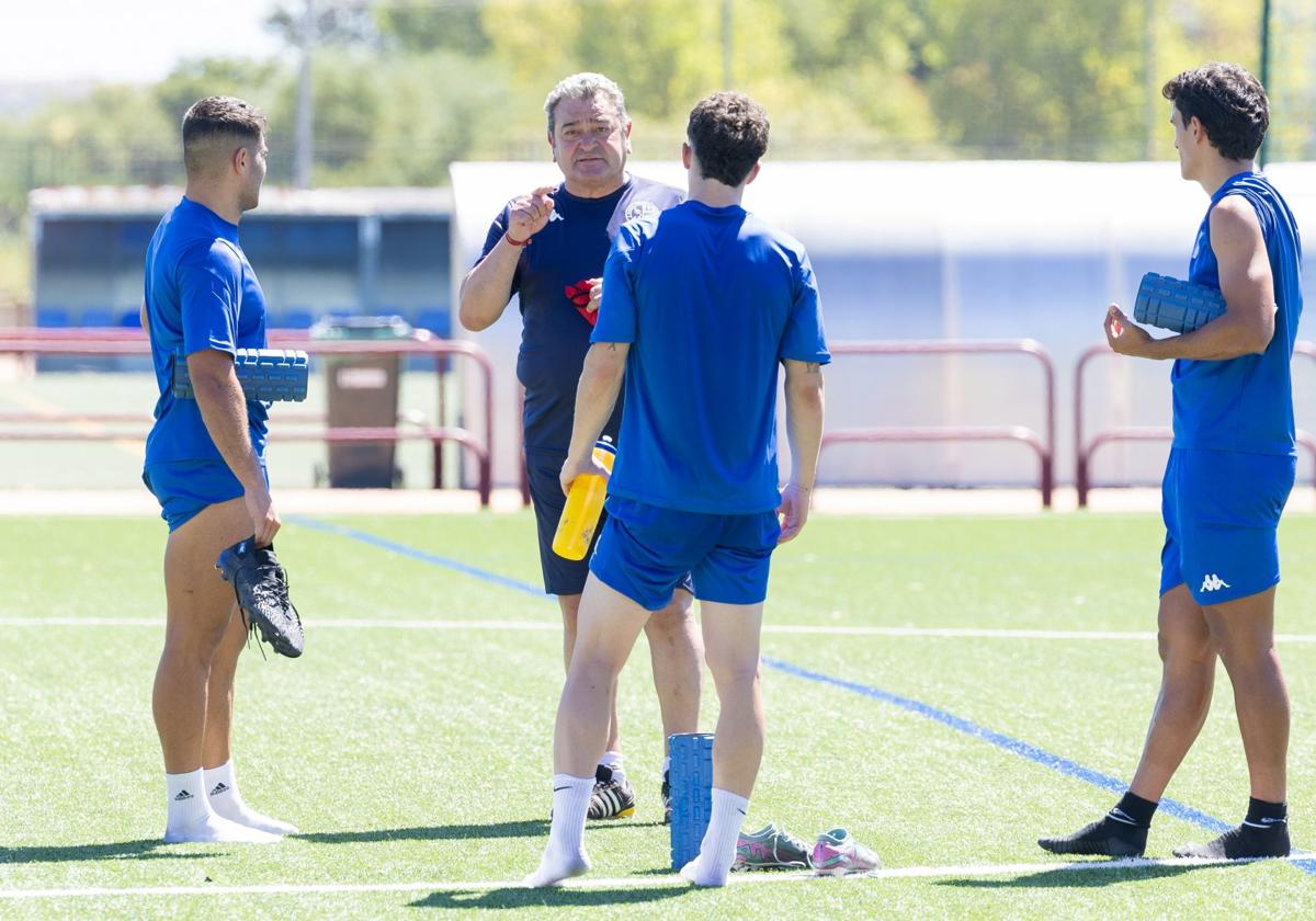 Carlos Pouso charla con dos jugadores al final de un entrenamiento de la SD Logroñés.