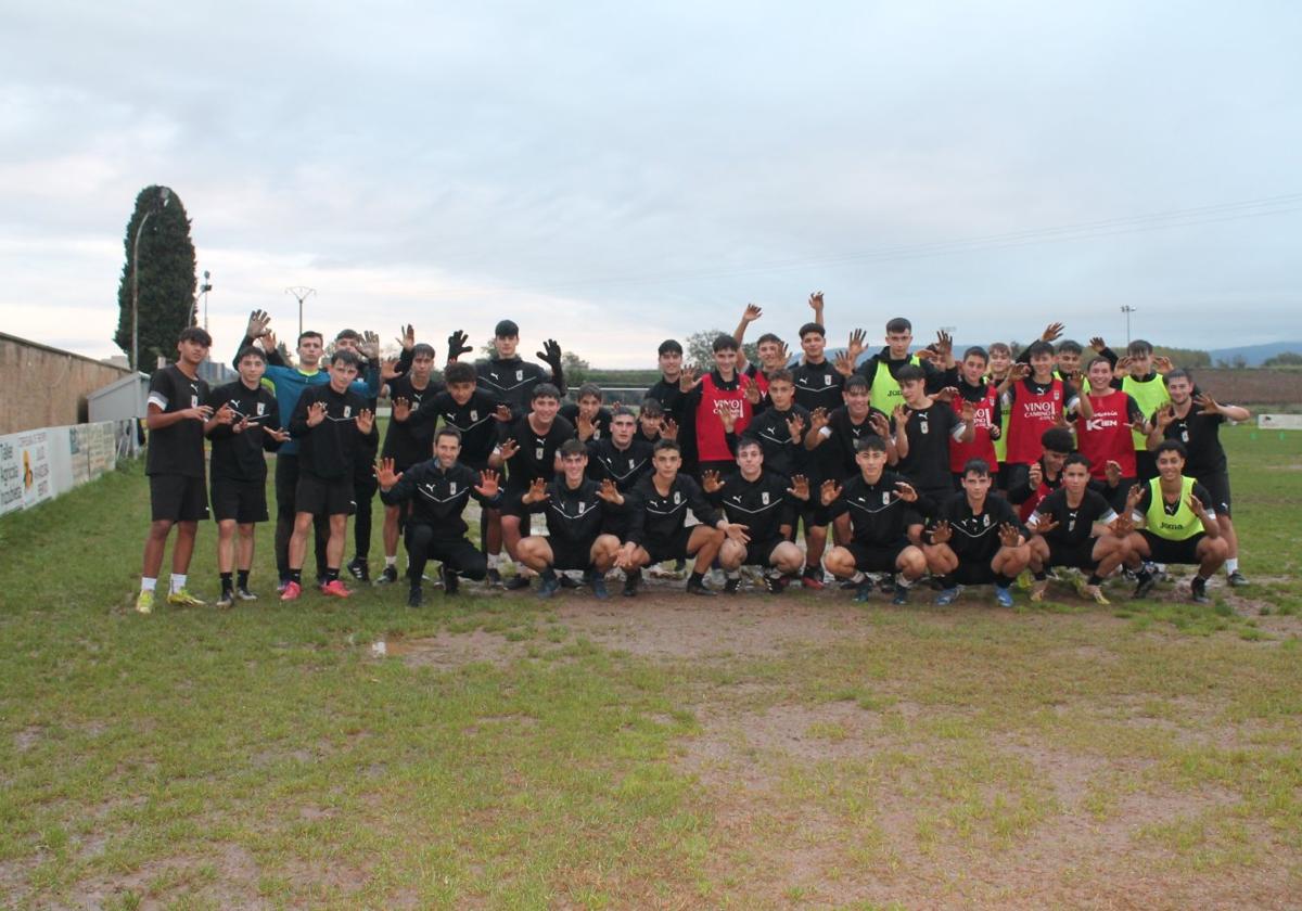 Los chavales del Juvenil enseñan sus manos manchadas de barro en el campo de 'El Cementerio'.