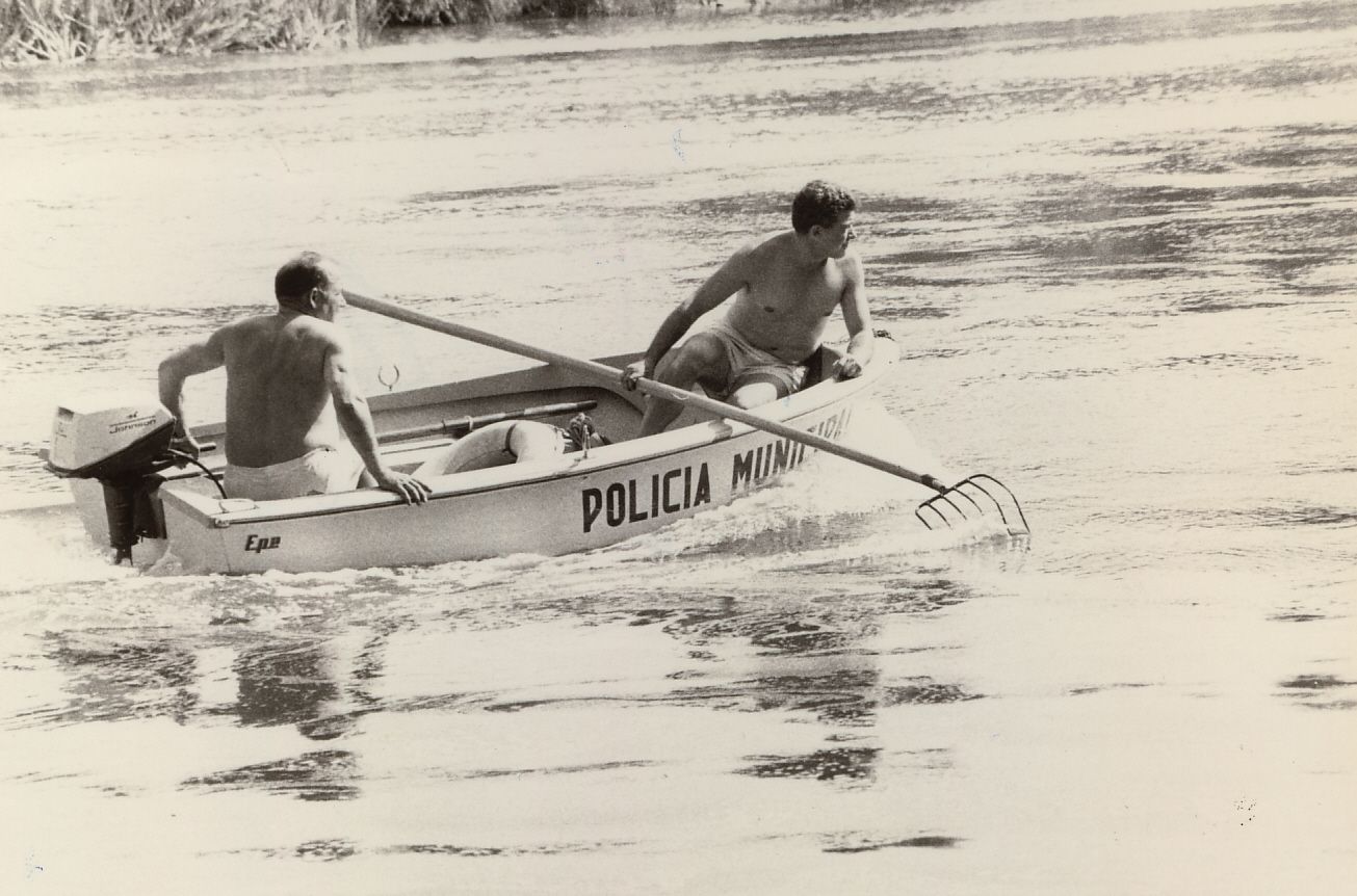 Labores de rastreo de dos agentes de la Policía Local en las aguas del río en los años 70, de Foto Herce.
