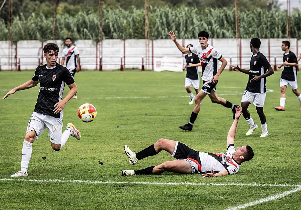 El local Asier cae en una disputa de balón al césped del Ángel Aguado y pide falta.