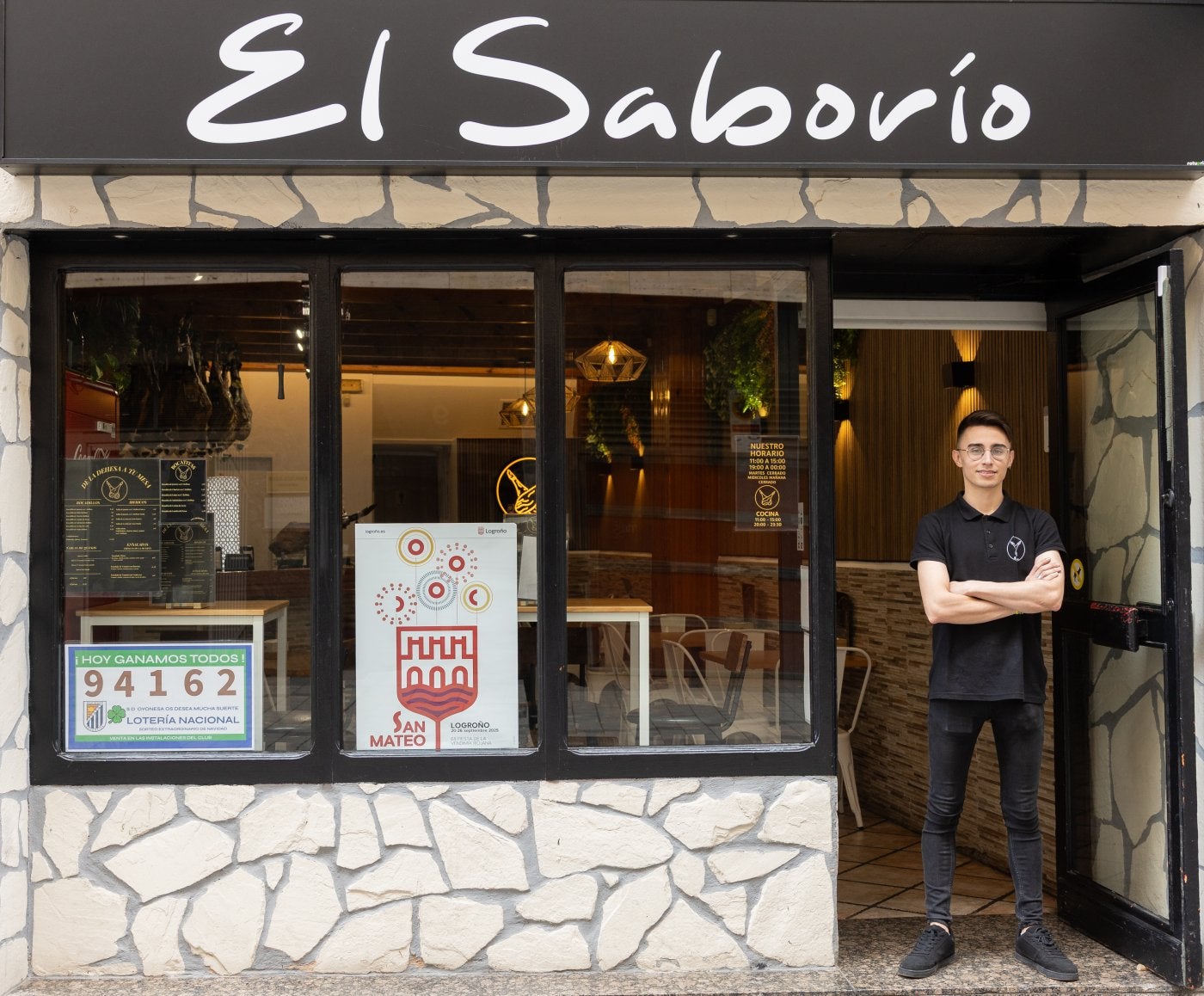 Luis Gustavo de Queiroz, a las puertas de su local. Sobre estas líneas, jamones de Los Romeros de Alanís.