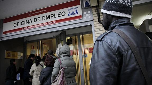 Varias personas, a las puertas de una oficina de empleo.