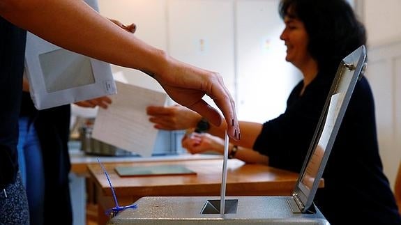 Personas depositando sus papeletas. 