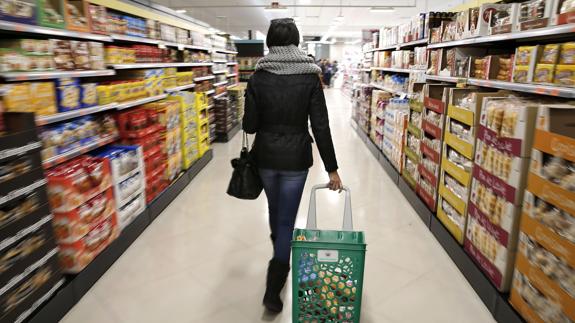 Una joven hace la compra en un supermercado.