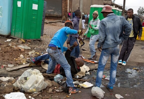 Imagen del apuñalamiento de Emmanuel Sithole. A la izquierda, los sospechosos del ataque. :: reuters y afp