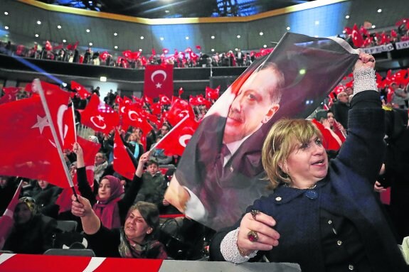 Seguidores de Erdogan enarbolan banderas turcas durante el acto electoral protagonizado por Yildirim. :: Wolfgang Rattay / reuters
