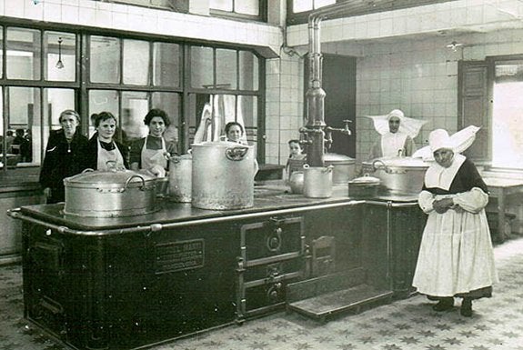 Hijas de la Caridad y sus ayudantes posan ante la cocina que daba de comer a los más necesitados de la ciudad. :: 