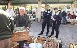 Agentes de la Policía Local de Logroño denunciando a un agricultor y obligándole a retirar la mercancía 'prohibida'. ::                         SONIA TERCERO