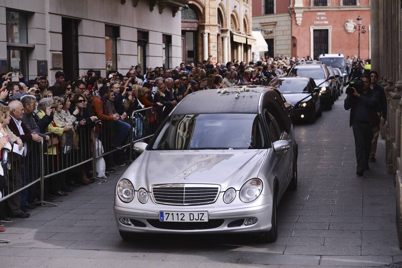 Claveles blancos sobre el coche fúnebre. 