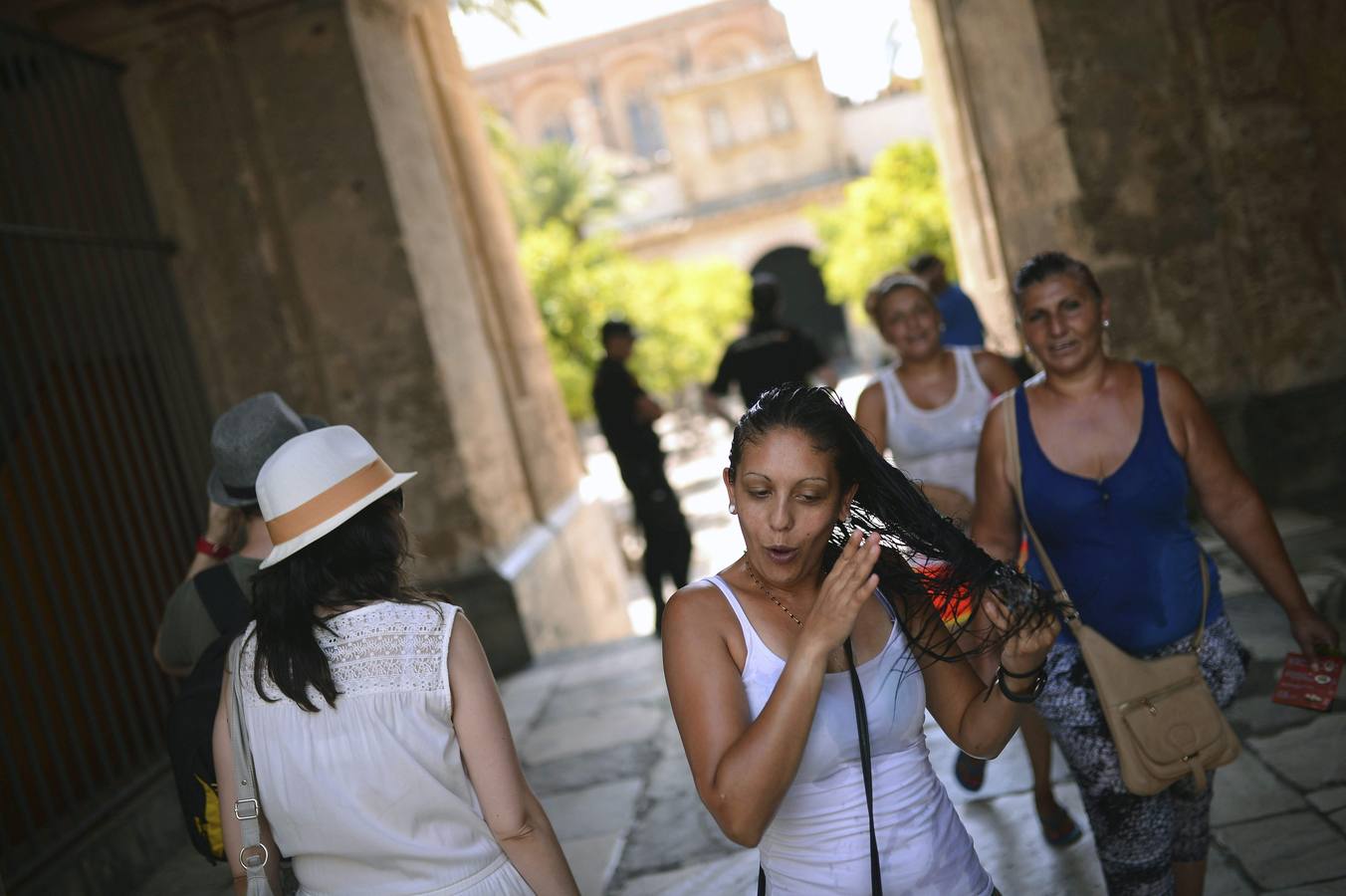 Tres mujeres se refrescan durante su visita a la Mezquita-Catedral de Córdoba.