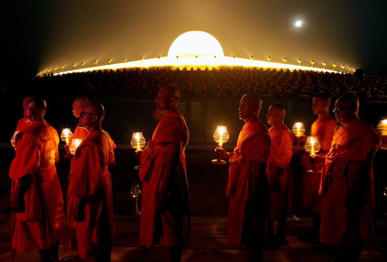 Monjes tailandeses caminan en círculo con velas en el Magha Puja, en el templo Wat Phra Dhammakaya, en la provincia Pathum Thani