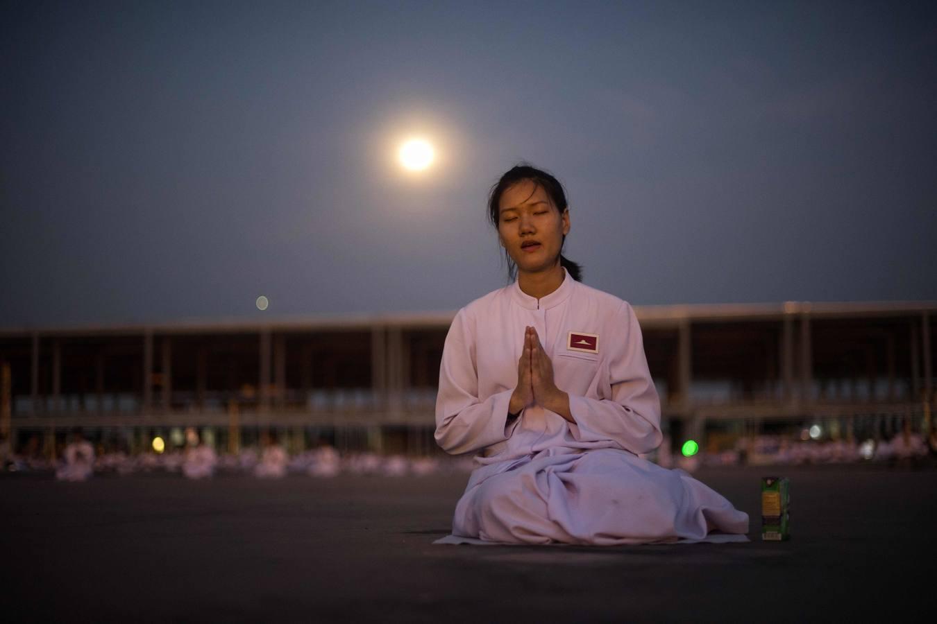 Monjes tailandeses caminan en círculo con velas en el Magha Puja, en el templo Wat Phra Dhammakaya, en la provincia Pathum Thani