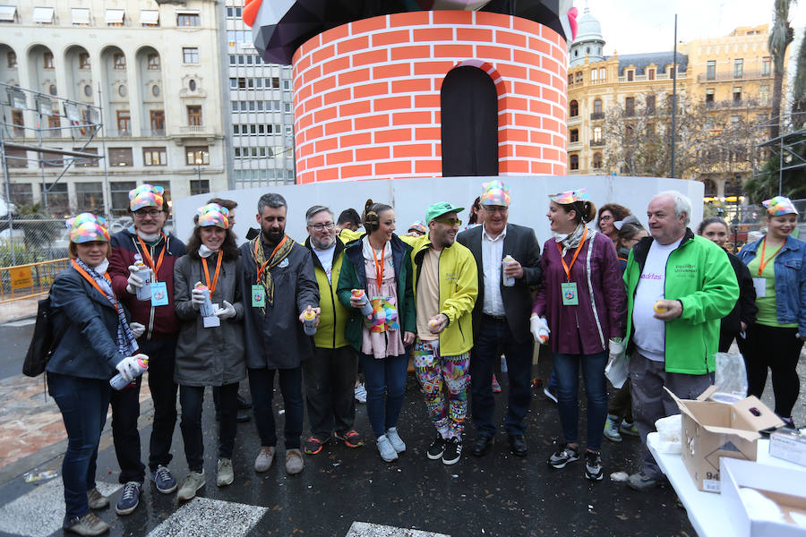 Representantes del munco fallero, social y político han participado en una actividad que consiste en pintar la base de la falla de la plaza del Ayuntamiento, obra de los artistas Okuda, Latorre y Sanz.