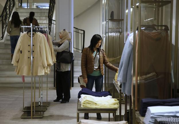 Una mujer mira las prendas en una de las tiendas de Zara. 