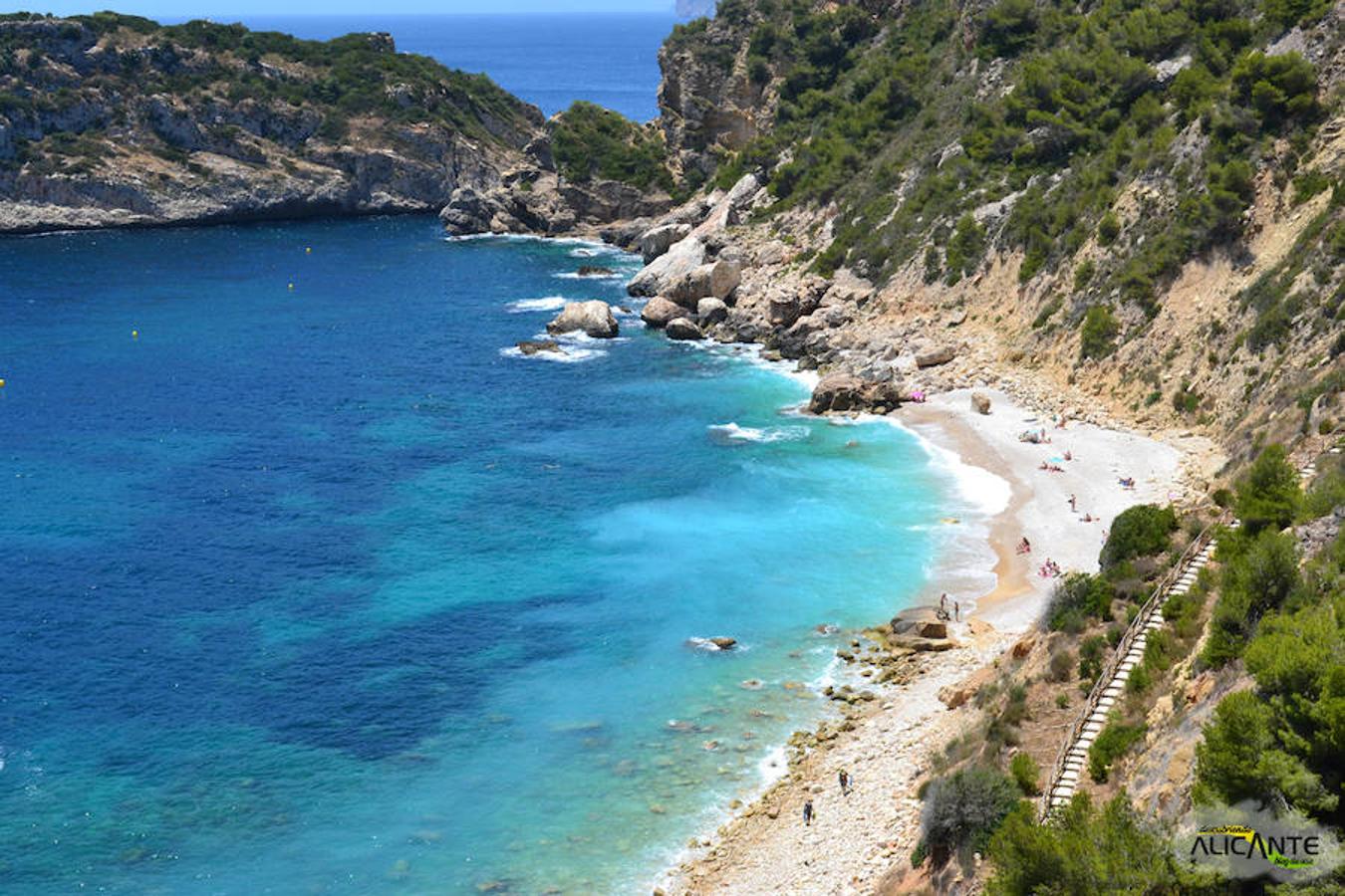 Cala Ambolo, Jávea. Ubicada al sur de Cabo de la Nao, es una de las pocas playas vírgenes que hay en la provincia. Con una longitud de 300 metros aproximadamente, es la opción ideal si quieres respirar paz y disfrutar de la calma de sus aguas. 