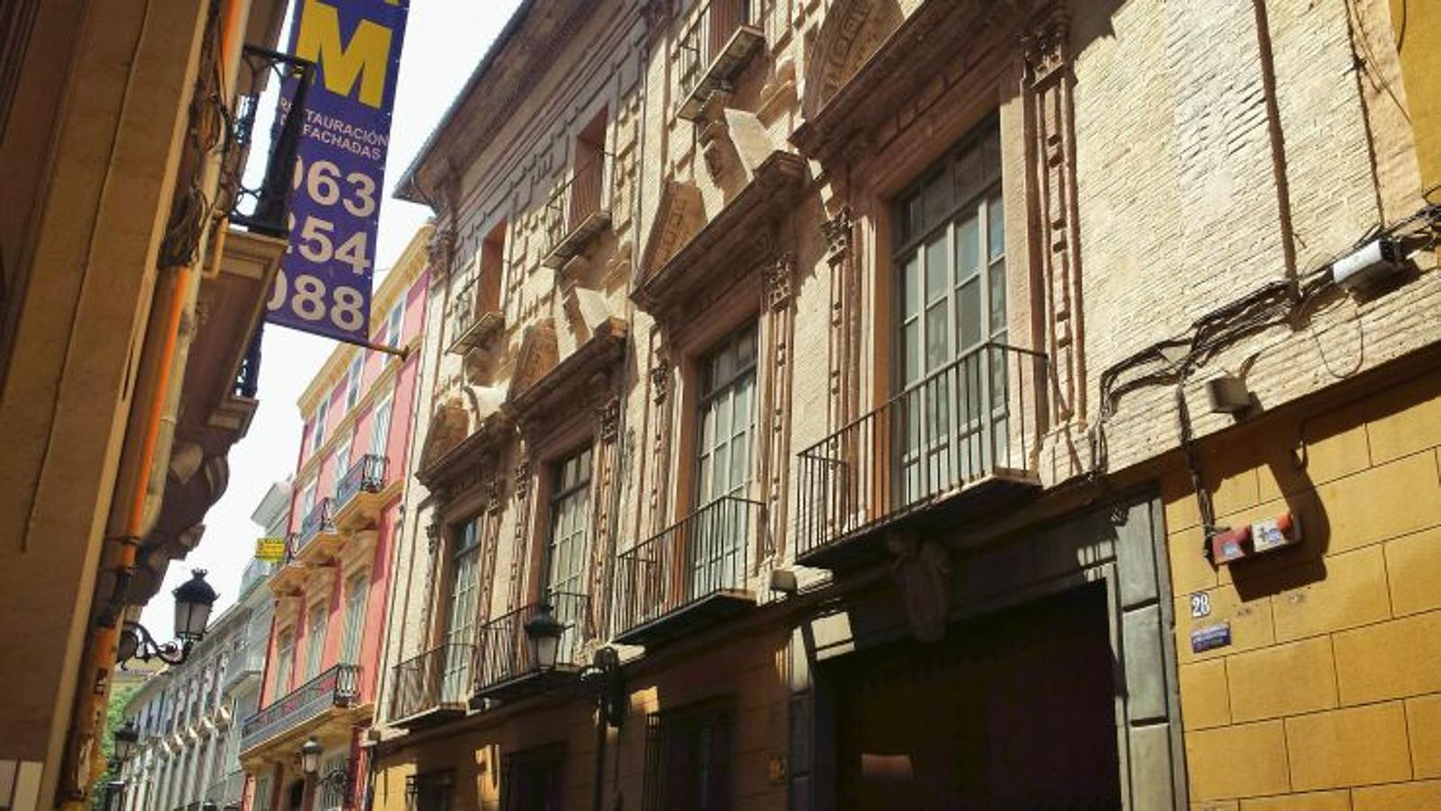 De origen gótico y con la típica estructura de las casonas solariegas valencianas (semisótano, entresuelo, piso principal y altillo), el palacio tiene una fachada barroca bastante sigular, al estar toda ella edificada de ladrillo visto y presentar balcones adintelados adornados con pilastras gigantes y con decorativos frontones partidos. En el siglo XVIII fue comprado por un caballero irlandés llamado Hollier, cuya hija, Isabel Hollier y Shelly se casó con Francisco Javier de Aspiroz y Montalvo, segundo conde de Alpuente, que le dio su nombre al palacio.