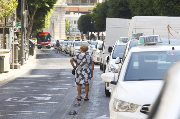 Una mujer, ayer, junto a la fila de taxis parados en la calle Colón. 