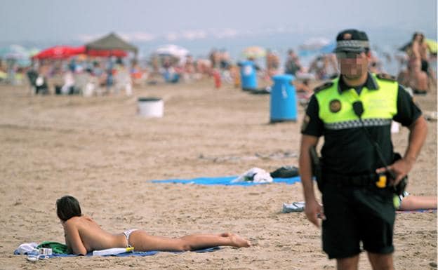Un agente, en la playa de la Malvarrosa de Valencia, en una imagen de archivo.