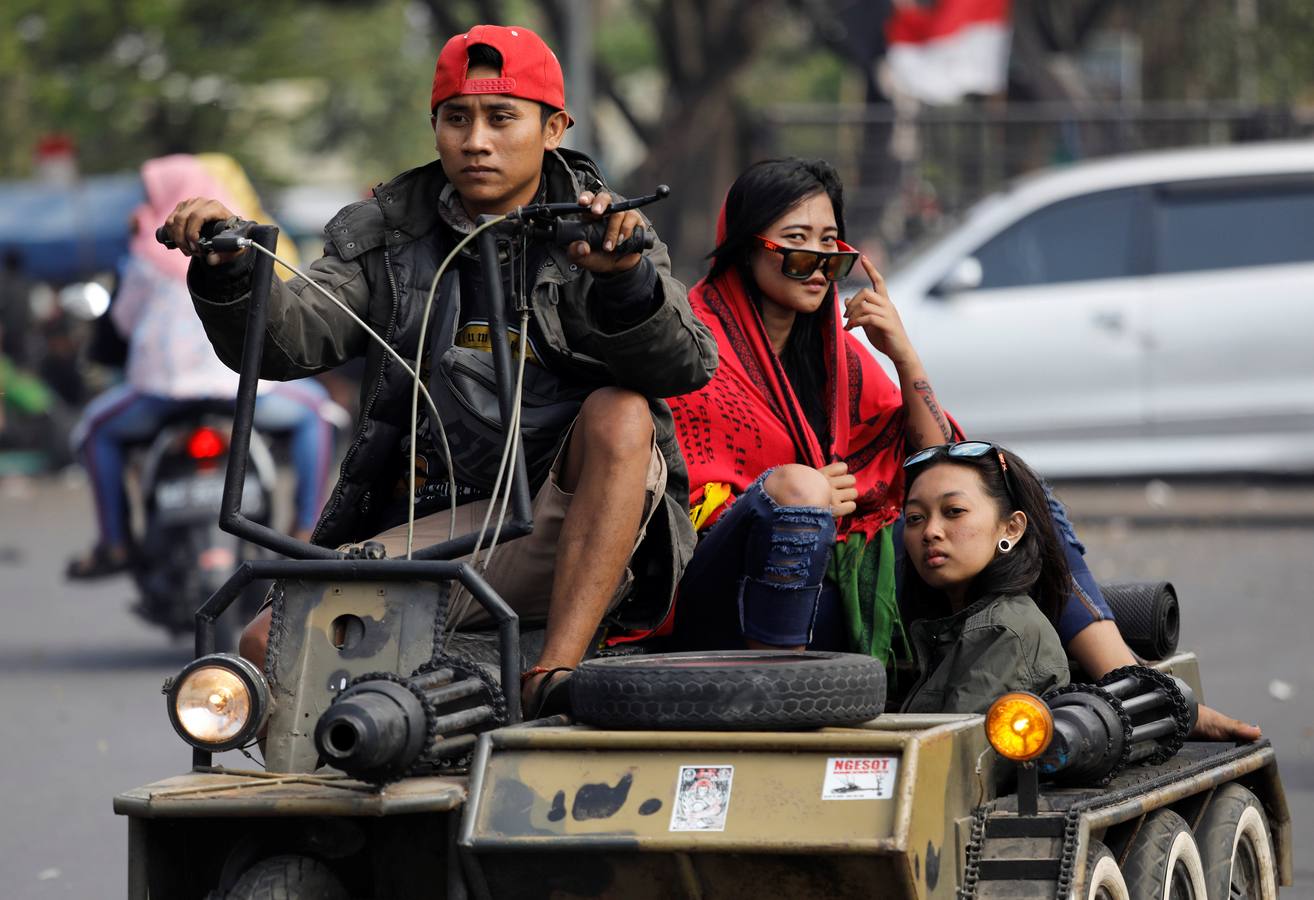 La Vespa convertida en 'monster-bike' al estilo 'Mad Max'. Cada año, desde adolescentes hasta abuelos indonesios se reúnen en la isla de Java para celebrar su pasión por el icónico 'scooter' italiano. Para algunos, es una especie de amor extremo, en el que los vehículos se personalizan o tunean para ver motos-monstruo sacadas de una distopía de Hollywood o una sociedad postapocalíptica. Cientos de entusiastas viajan al festival en Kediri y presumen de sus creaciones, desde Vespas antiguas restauradas hasta tanques de 'Mad Max' equipados con ametralladoras falsas, una docena de neumáticos adicionales o peluches de adorno.