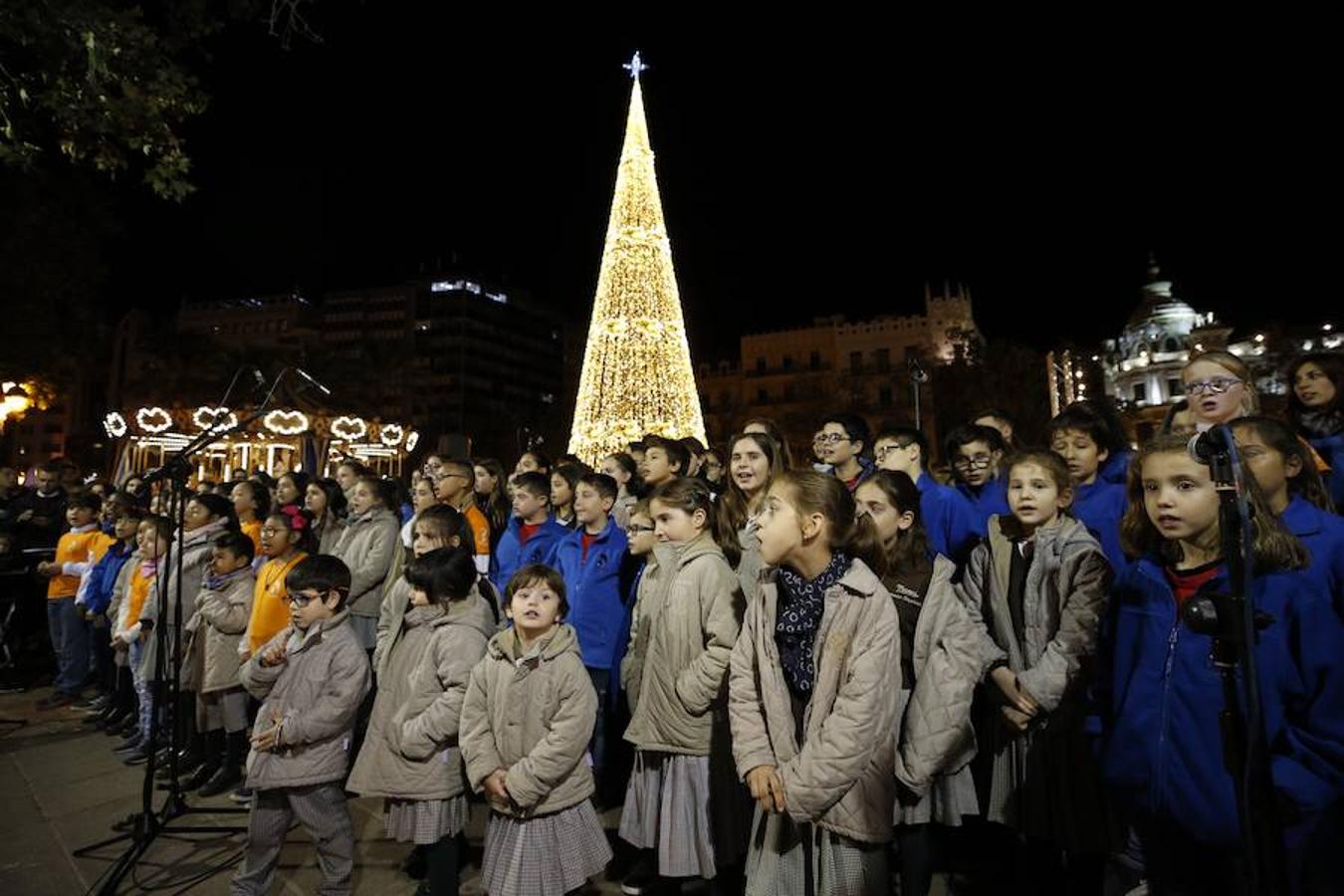 La Plaza del Ayuntamiento de Valencia ha vivido este viernes el encendido oficial de la iluminación navideña. Como gran novedad, este año otros dos barrios y dos pueblos de la ciudad se suman en la apuesta por descentralizar la decoración. Los dos barrios que este año estrenarán árbol de Navidad serán Benicalap y Malilla, sumándose así a las plazas de Patraix, Campanar, Benimaclet, Sant Valer (en Russafa), la Creu del Canyamelar y Doctor Collado (en Ciutat Vella), Orriols, Sant Marcel·lí y Abastos. Serán un total de 11 los árboles que se repartirán por toda la ciudad, además del de la Plaza del Ayuntamiento.