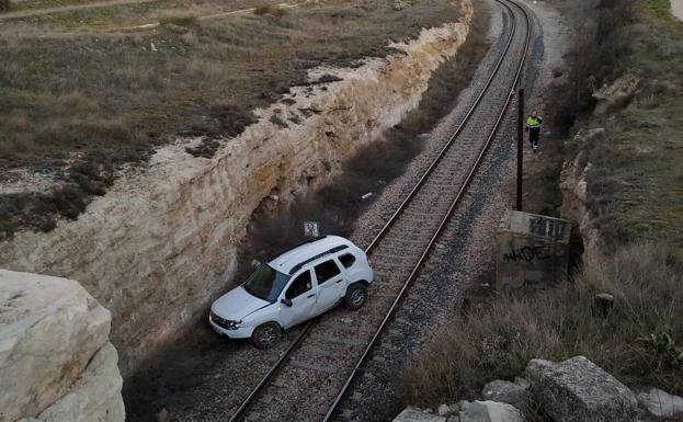 El vehículo tras caer a las vías del tren a las afueras de Requena.