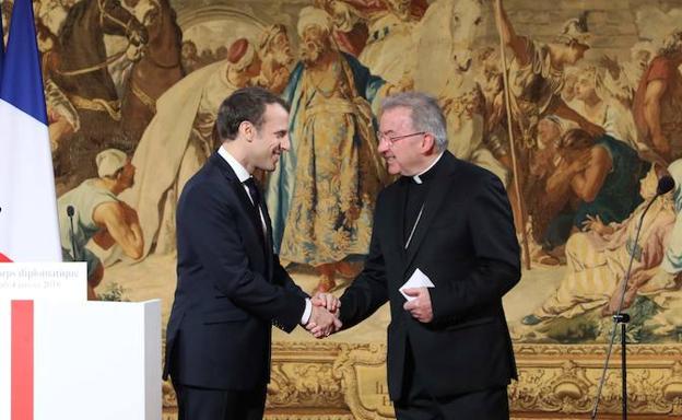 El presidente francés, Emannuel Macron, saluda al nuncio apostólico, Luigi Ventura, durante una recepción en el palacio del Eliseo.