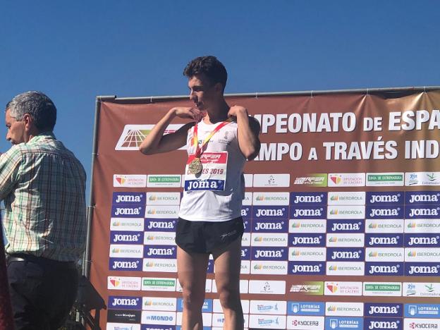 Miguel Baidal se acomoda la medalla de oro al cuello en el podio de Cáceres. 