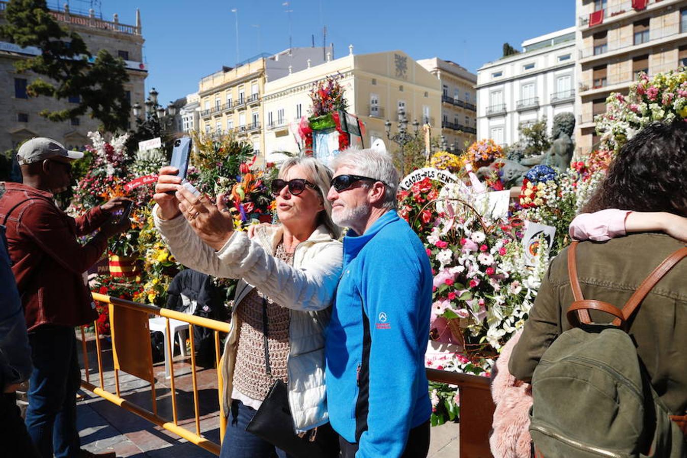 La Ofrenda concluyó este lunes después de que miles de falleros desfilaran para llevar las flores a la Virgen de los Desamparados. Este martes, a la luz del día se ha desvelado ante los ojos de los valencianos el aspecto definitivo del manto de la 'Geperudeta'. Claveles blancos, rojos y rosas componen componen el diseño del vestidor Rafael Chordá. Un floreado manto con el blanco como color predominante y que preside estos días la plaza de la Virgen, ante su basílica.