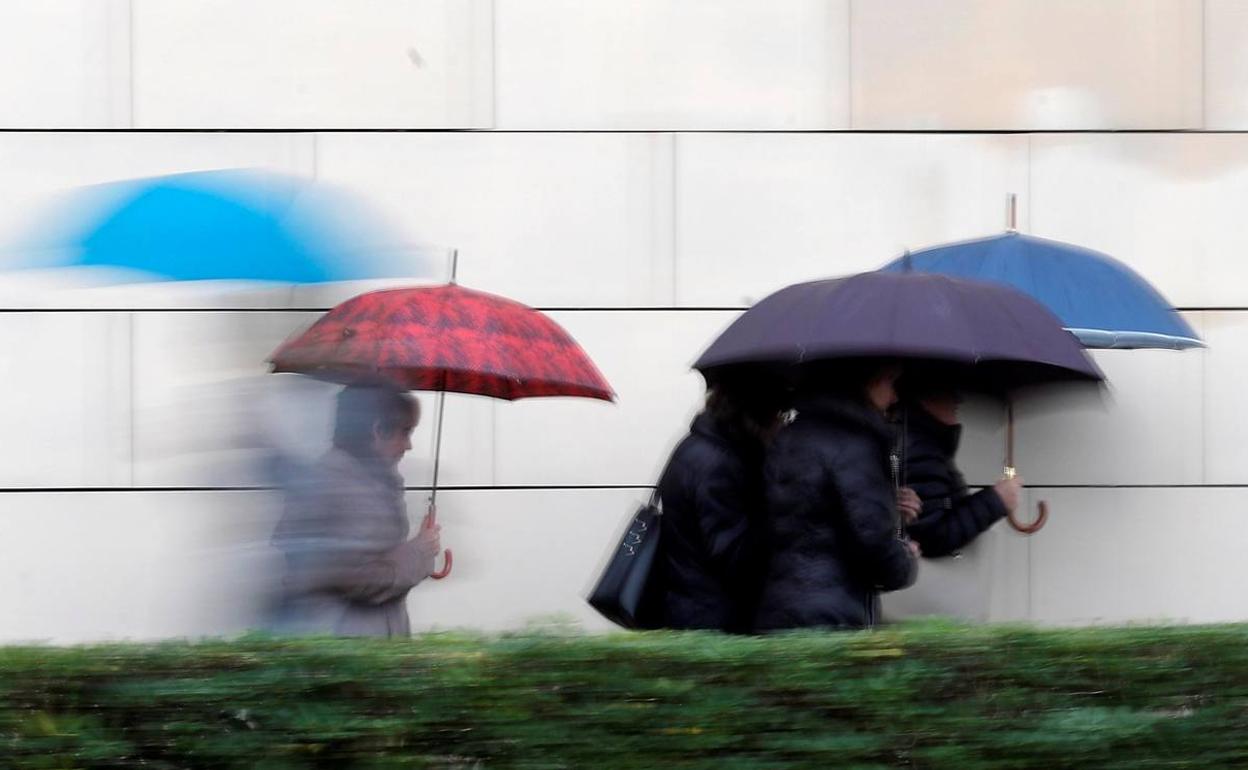 Varias personas se protegen de la lluvia, hace unos días en Valencia.