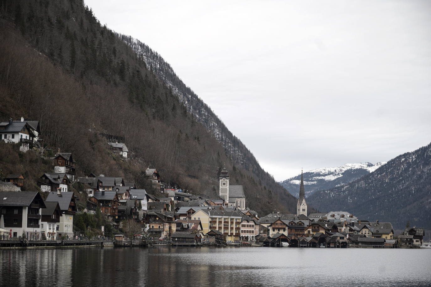 Hallstatt era hace diez años una villa idílica al borde de un lago de ensueño y aún lo sigue siendo, pero de otra manera. Lo que entonces le faltaba al pequeño pueblo austriaco, ahora le sobra. Tiene gente para dar y regalar, la hay por todas partes, tanta que hasta los visitantes se cuelan sin permiso en las casas en busca de un baño que no esté ocupado. En el pueblo residen 778 vecinos pero no lo parece porque apenas se les ve. Su presencia se diluye ante las riadas de personas que transitan por las calles en busca de un lugar vacío donde sacarse una foto mientras decenas de drones sobrevuelan los tejados para obtener imágenes impactantes. Hay turistas que llegan a la localidad convencidos de que se encuentran en un parque temático donde todo es de cartón piedra y todo está a la venta. Otros creen que están recorriendo el auténtico Arendelle, el reino de la película 'Frozen'. Hallstatt es un pueblo de moda, hasta ha sido calificado como «el más 'instagrameable' del mundo», y eso está siendo su ruina.