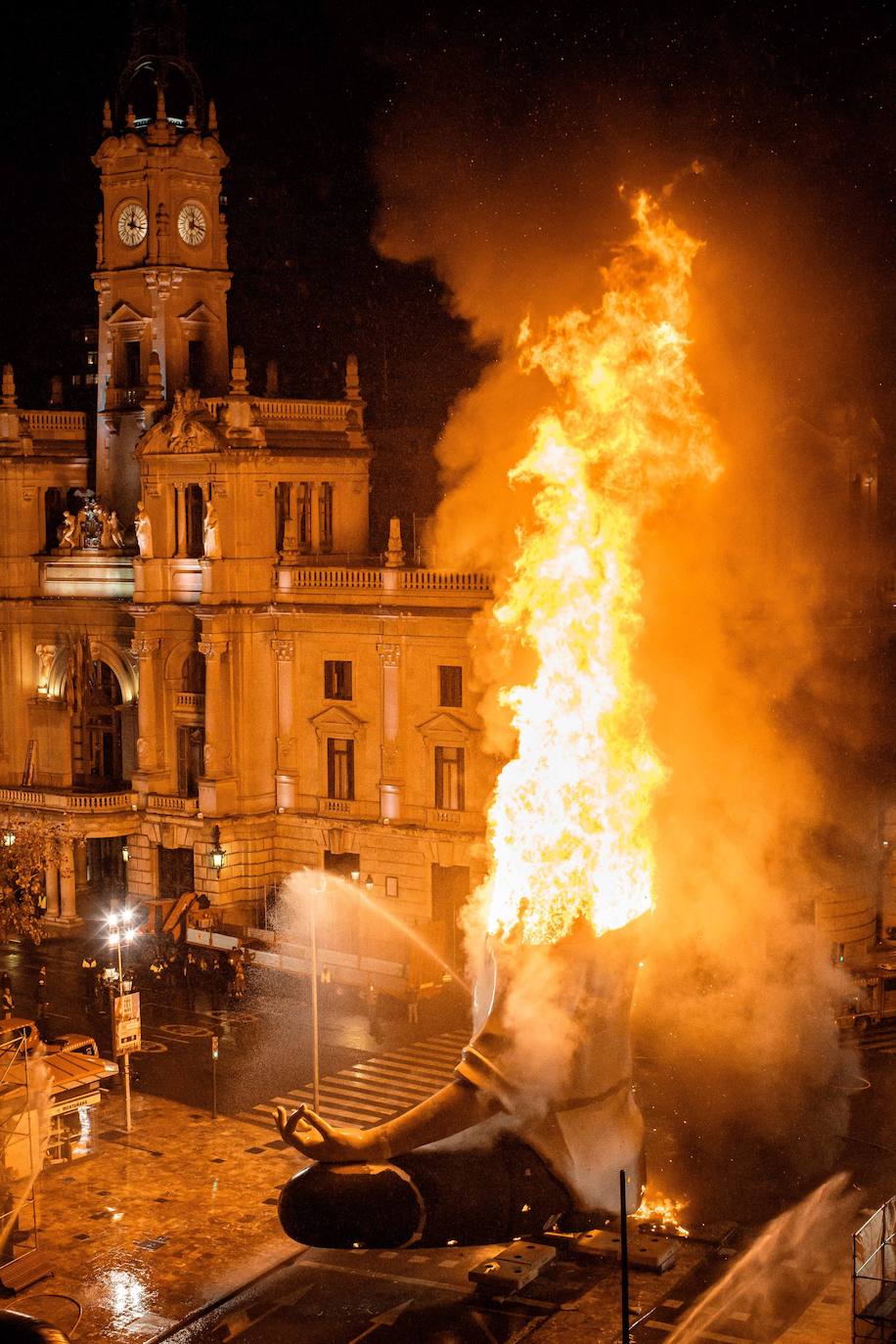 Los bomberos hacen arder la parte ya plantada de la falla del Ayuntamiento. La cabeza de la chica se guardará para la celebración de julio.