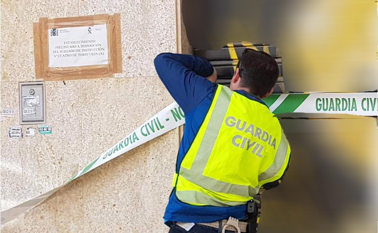 Un agente precinta el gimnasio en Torrevieja. 